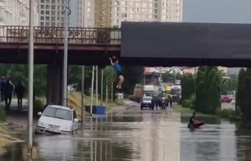 (ВИДЕО) ЕДЕН СКОКНА ОД МОСТ, ДРУГ ПЛОВЕШЕ СО ЧАМЕЦ: Скопјани се забавуваа на поплавена улица
